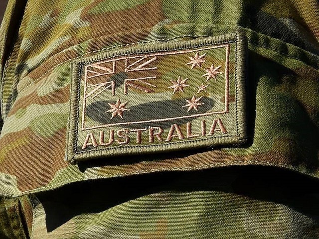 Extreme close-up of shoulder of a khaki military uniform. There is a patch with the Australian flag with text &quot;Australia&quot;.