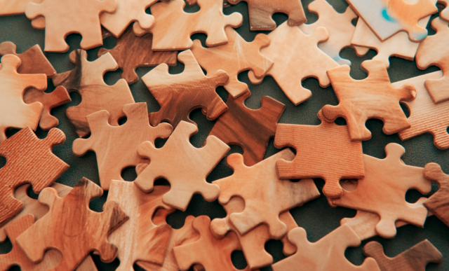 picture of wood-textured puzzle pieces.