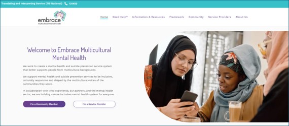 Updated Embrace website homepage, with links to information for community members and professionals. Image of three women looking at a phone. 