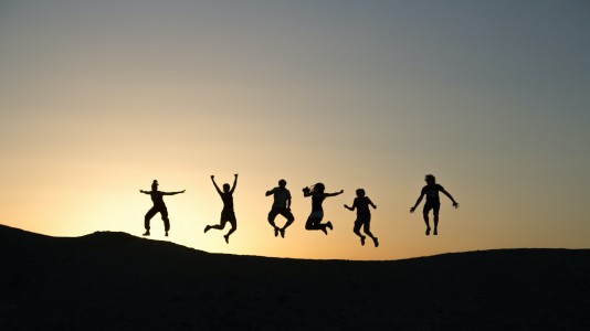 Jumping group at sunrise